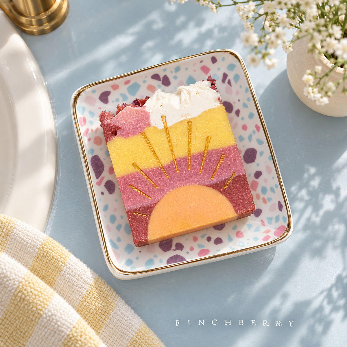 One Hello Sunshine soap bar on Finchberry pastel terrazzo dish beside a sunlit sink