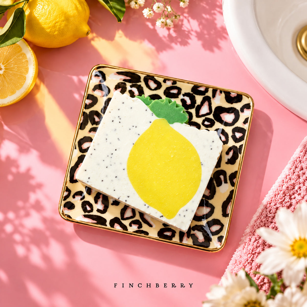 Leopard ceramic soap dish styled with lemon-design soap on a pink bathroom counter; soap sold separately