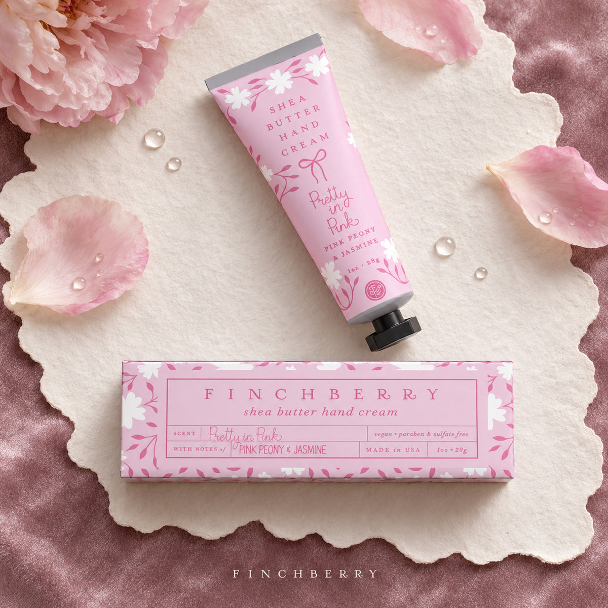 Pretty in Pink hand cream and its box on textured paper