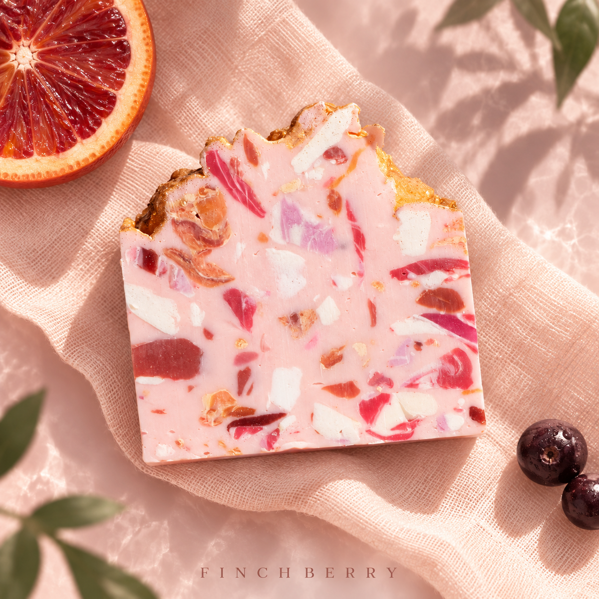 One Rose terrazzo soap bar on apricot linen and blush glass