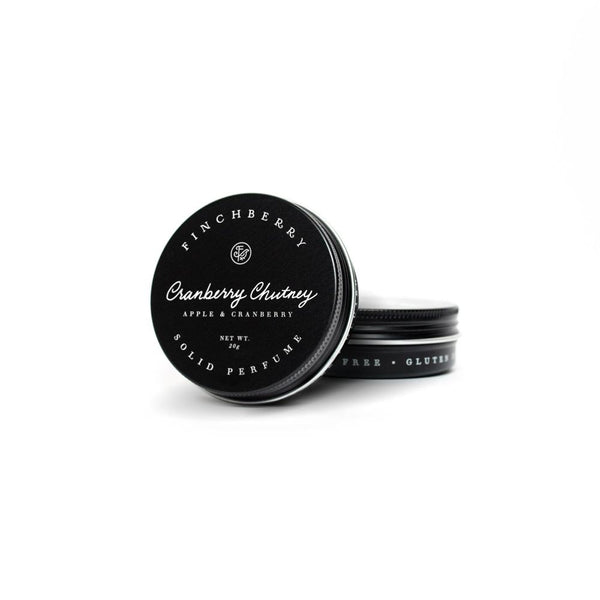 Cranberry Chutney Solid Perfume in black circular tin container with white lettering